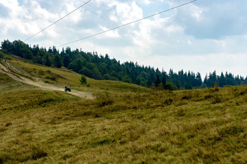 The ATV rides the mountain road