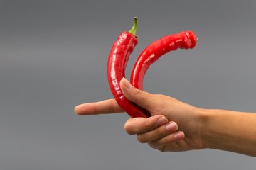Hand with bottle of pepper spray isolated on gray background.
