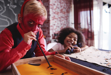 Boy in devil costume at party game