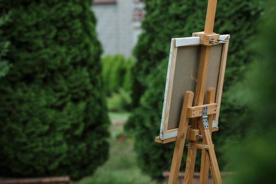 easel with canvas in garden.