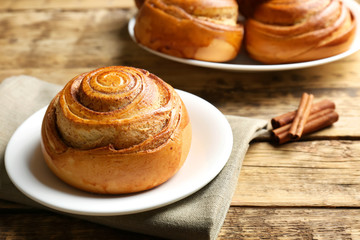 Sweet cinnamon roll on plate