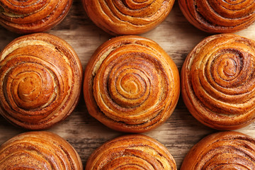 Sweet cinnamon rolls on wooden table