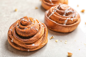 Sweet cinnamon rolls on gray table