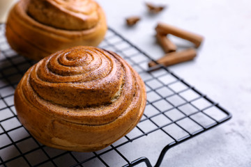 Sweet cinnamon rolls on cooling rack
