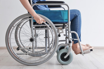 Fototapeta na wymiar Young woman in wheelchair at home