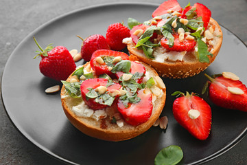 Delicious sandwiches with strawberry, basil and peanut on plate