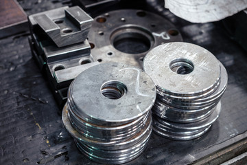 Two piles of round metal washers.