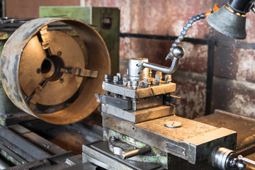 Old vintage lathe in the factory shop.