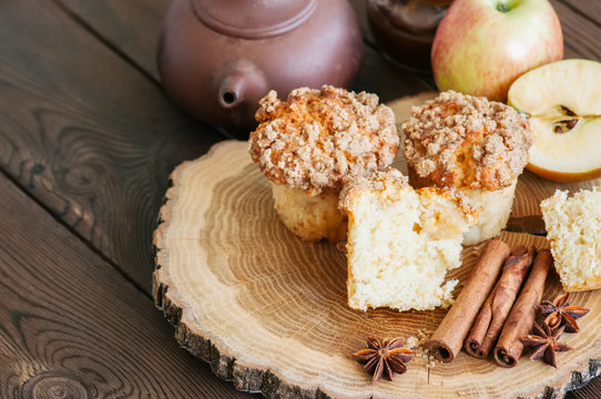 Apple cinnamon streusel muffins on a wooden board. Wooden background.