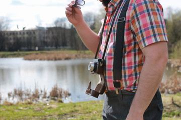 beard man with retro camera in the park