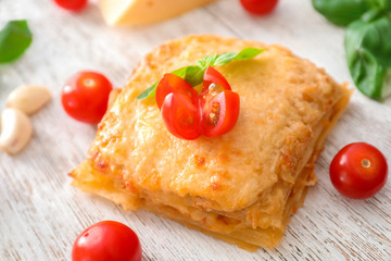 Tasty lasagna on wooden table