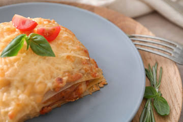 Plate with tasty lasagna on table