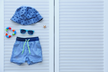 Set of baby beach accessories on light background