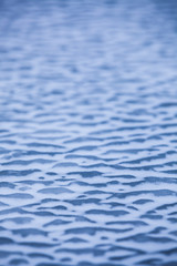 Frozen rippled sea water graduating depth of field