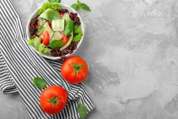 Delicious vegetable salad with cucumbers in bowl on table