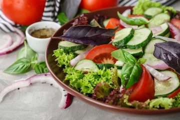 Delicious vegetable salad with cucumbers in bowl on table, closeup
