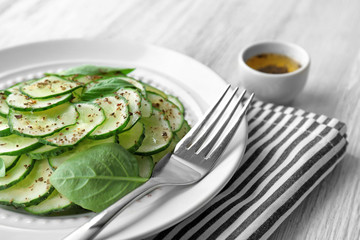 Cucumber salad in plate on table, closeup