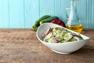 Cucumber salad in plate on table