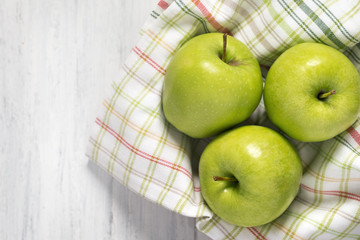 Green apples on a wooden table, top view
