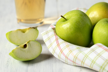 Green apples and Apple slices on a wooden table