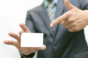 Fototapeta premium Business man is holding a business card by one hand and shows on her the index finger of the other hand. Visit card.