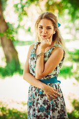 Fototapeta premium Young beautiful girl in floral dress