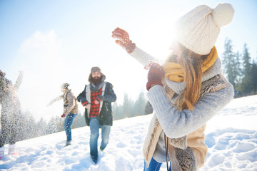 Young couple in snowball fight