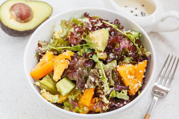 Bright colorful salad with couscous and vegetables, ingredients on the table, vegan lunch, top view.