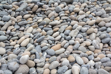 Abstract background with dry sea round reeble stones with white streaks