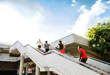 Young people in the city running up the stairs.