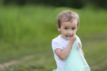 Girl Toddler Playing On Green Glade, Copy Space