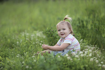 Fototapeta premium girl Toddler with a funny tail on green glade
