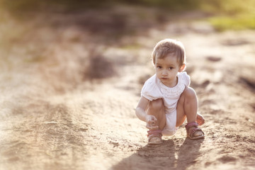 funny girl Toddler baby sitting on the road