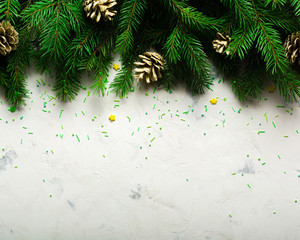 Christmas and New Year background. Christmas tree branch on a white background. A gift for the family. View from above.