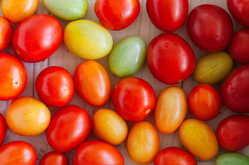 Fototapeta na wymiar Background of bright colorful tomatoes cherry. Top view.