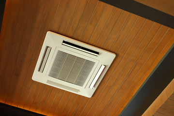 air conditioner cooling cassette type electric equipment on wooden ceiling interior