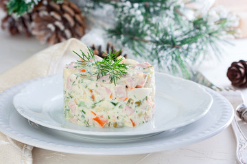 New Year's salad Olivier on a white plate, horizontal
