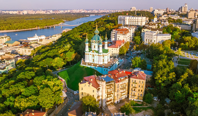 Aerial top view of Saint Andrew's church and Andreevska street from above, cityscape of Podol district on sunset, city of Kiev (Kyiv), Ukraine
