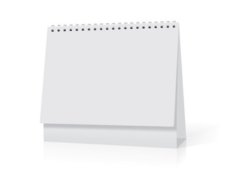 A white paper  calendar stands on the table