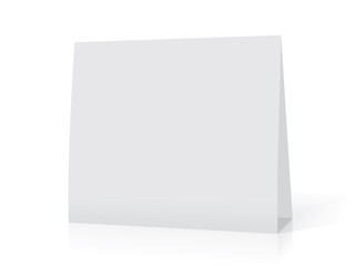 A white paper  calendar stands on the table