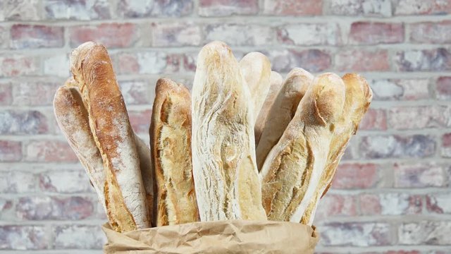 many french baguettes bread in paper bag, rotation