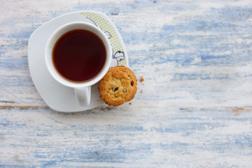 Close up cup of tea with cookes on the woooden rural table
