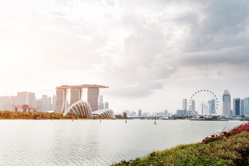 Fototapeta premium modern buildings near water in midtown of modern city in cloud sky