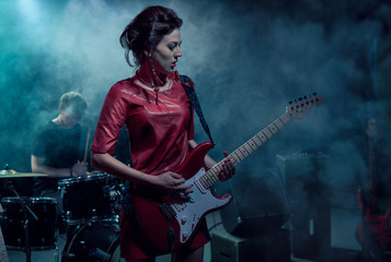 Fototapeta na wymiar Girl-guitar player plays solo.