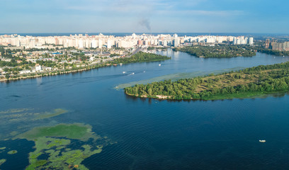 Aerial top view of Darnitsky bridge, Dnieper river and cityscape from above, city of Kiev, Ukraine

