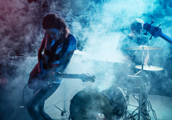 Girl-guitar player plays solo.
