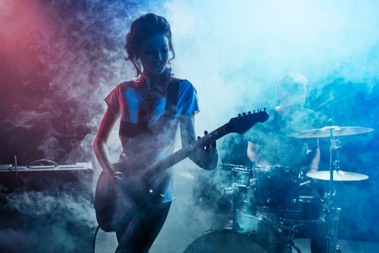 Girl-guitar player plays solo.