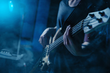 Naklejka premium The bass guitar player plays solo.