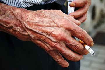 old man's hand with a cigar