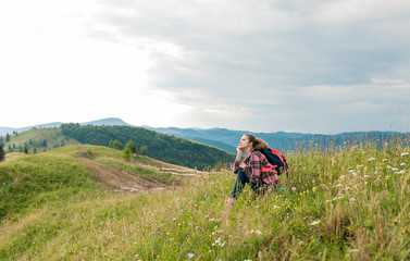 Yound girl on peak mountain with perfect view.